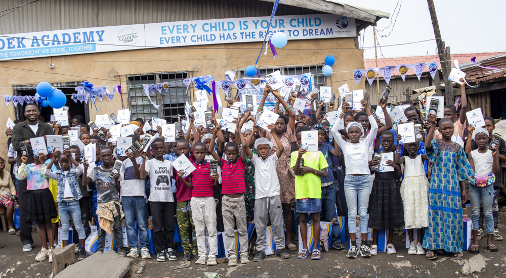 Students in chef's apparels Displaying food made at Summer School